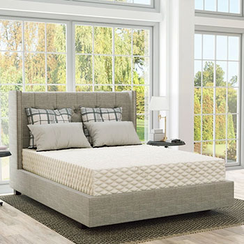 A bedroom with a PlushBeds Natural Bliss Natural Latex Vegan Mattress